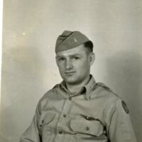 Photo of Lt. Robert Adams, in uniform, holding the number 45.